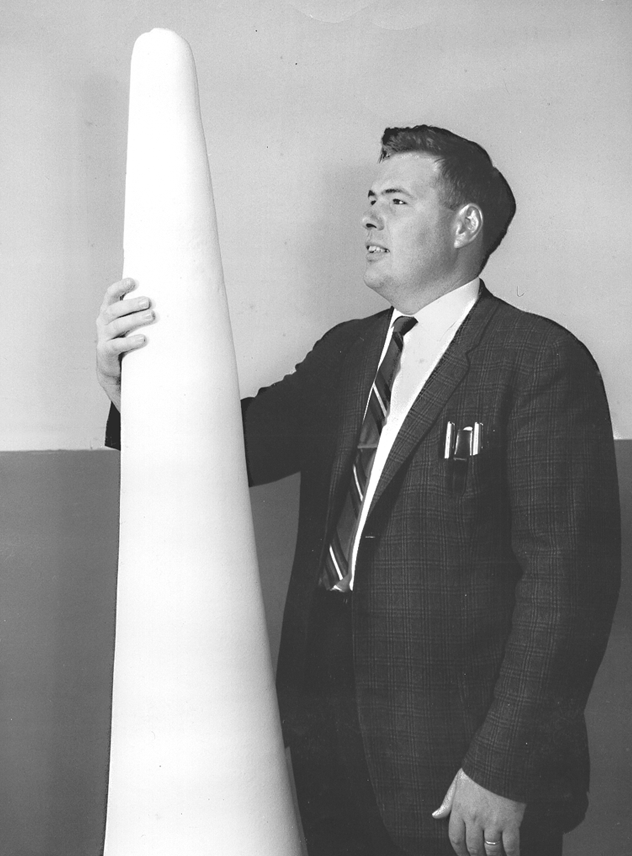 Frank Chapman standing next to first fluoropolymer missile nose cone