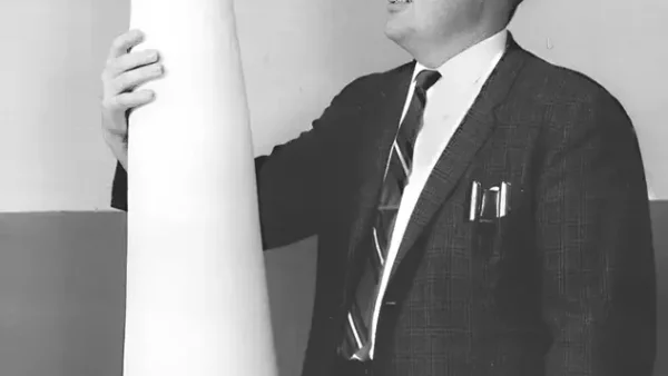 Frank Chapman standing next to the first fluoropolymer missile nose cone